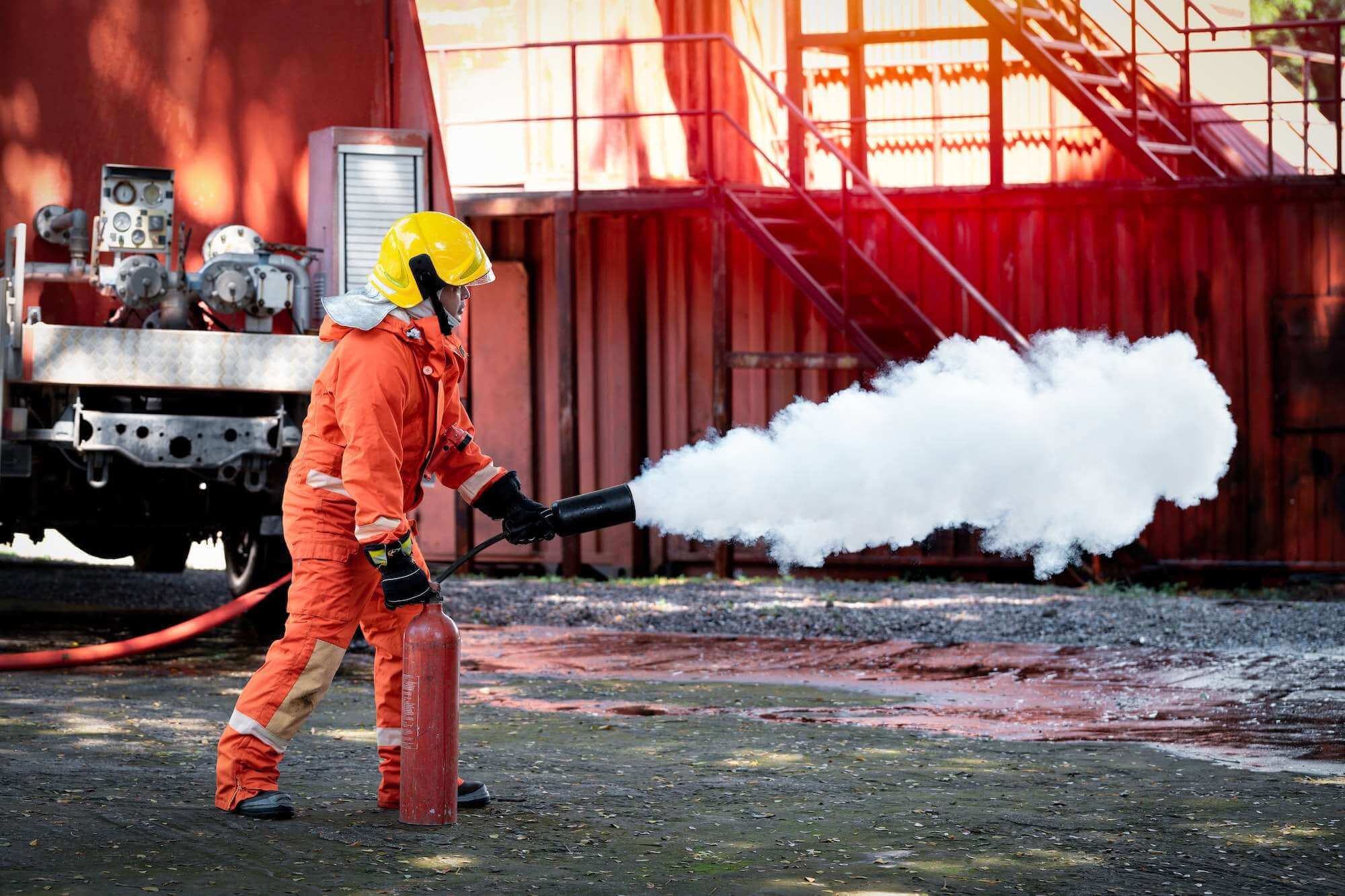 Fire Marshall Course - Fireman wearing firefighting suite using fire extinguisher fighting fire equipment and accessories